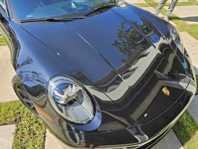 Black Porsche 911 hood with mirror reflections