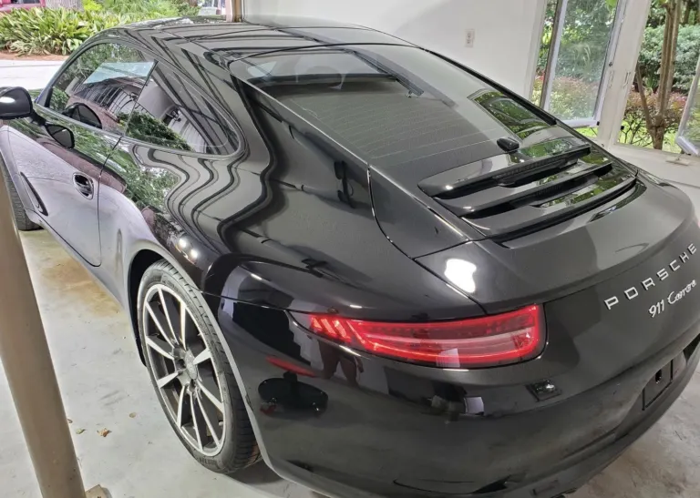 Black Porsche 911 with reflections in the paint