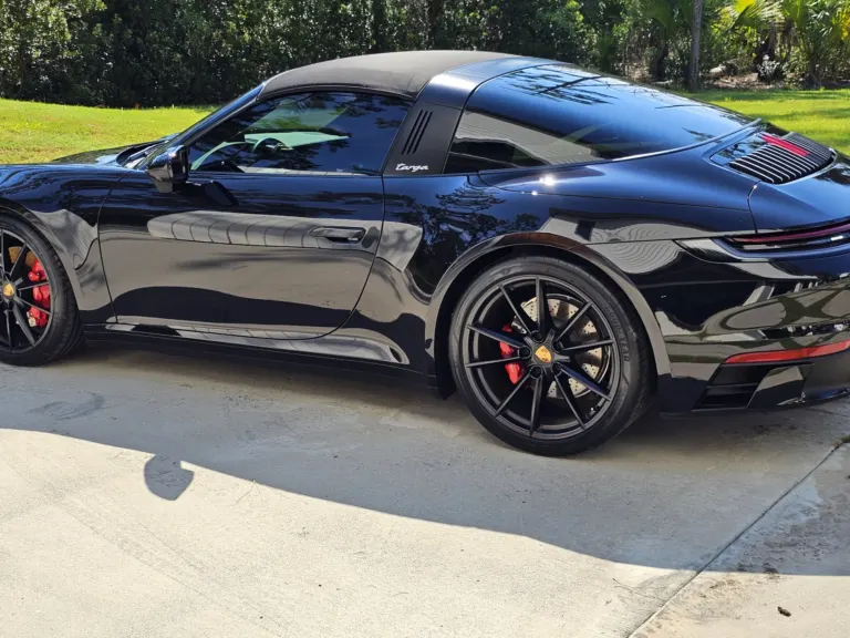 Black Porsche 911 Targa with a deep gloss, side view