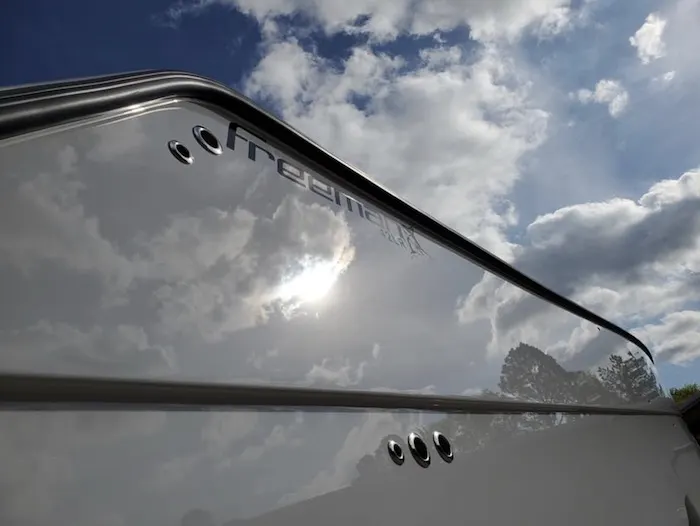 Glossy boat hull against the sky