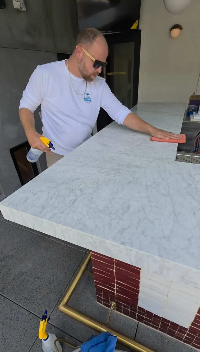 Finishing clear film on a marble bar counter in Savannah GA