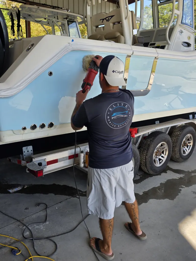 Machine polishing the gelcoat on a light blue center console in the Elite shop