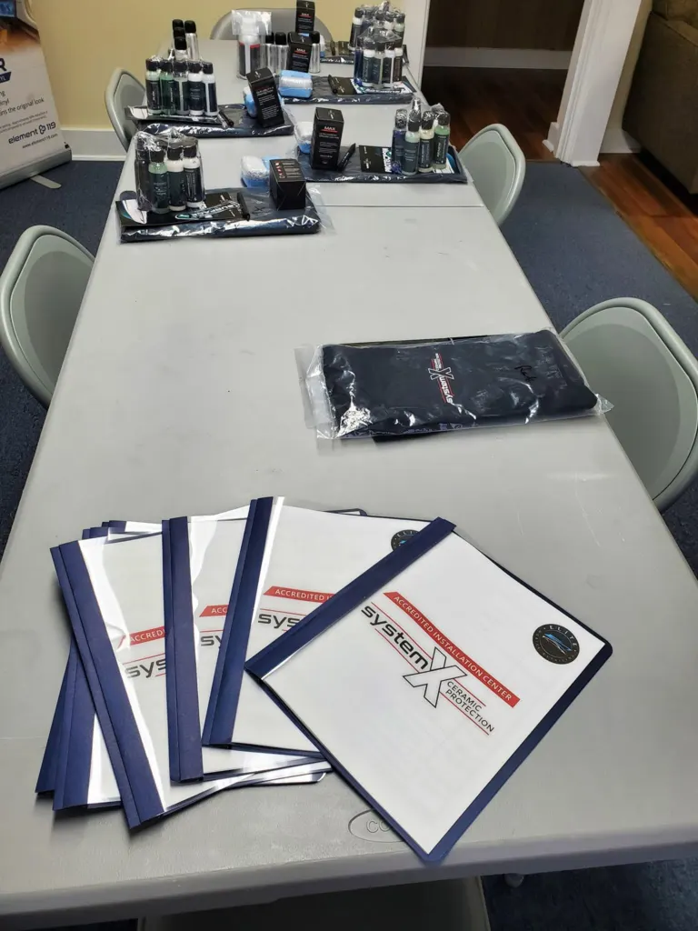 System X training binders and coating kits set out for a training class